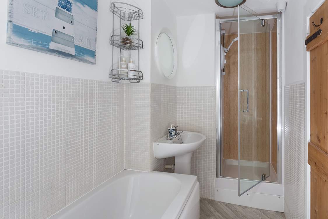 The compact family bathroom has a lovely shower cubicle.