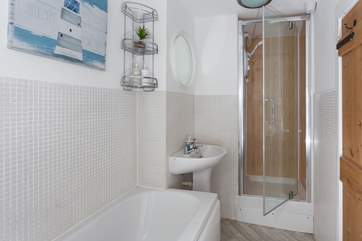 The compact family bathroom has a lovely shower cubicle.