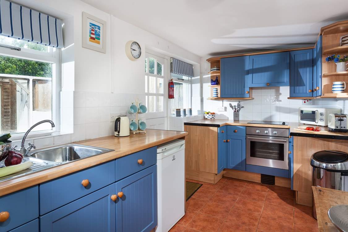 The cute kitchen is very well-equipped.