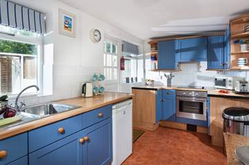 The cute kitchen is very well-equipped.