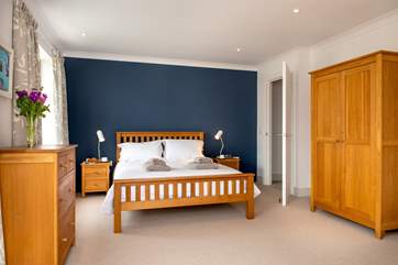 The master bedroom on the second floor is decorated with seaside tones (Bedroom 2).