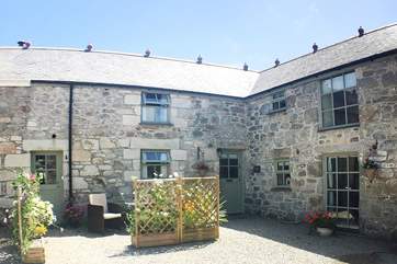 The Croft nestles between a neighbour and the owners' home (on the right).