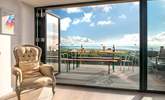 The large picture window, which leads out to the decking area, takes full advantage of the spectacular view. - Thumbnail Image