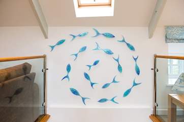 A beautiful glass fish sculpture adorns the stairwell.