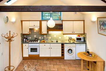 The lovely painted kitchen is very spacious.....