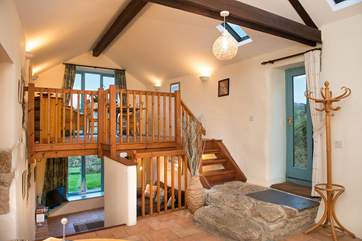 The kitchen, bedroom and bathroom are on the ground floor of this spacious barn conversion with stairs leading up to the dining-room and down to the sitting-room.
