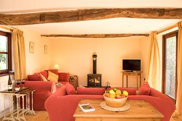 The double aspect sitting-room has views over the garden and the lane.