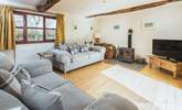 The double aspect sitting-room has views over the garden and the lane and enjoys the joy of a log burner for those cosy nights.  - Thumbnail Image