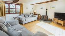 The double aspect sitting-room has views over the garden and the lane and benefits from a wood-burner for those cosy nights. 