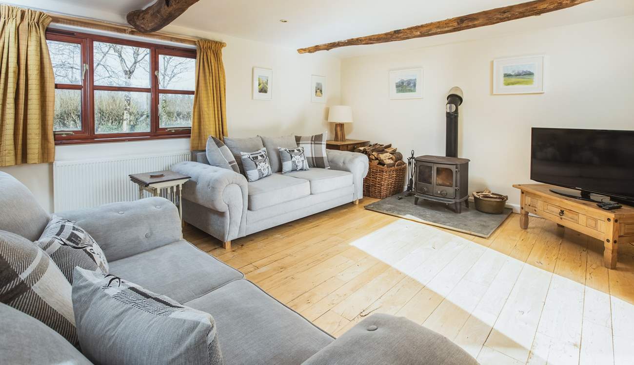 The double aspect sitting-room has views over the garden and the lane and benefits from a wood-burner for those cosy nights. 