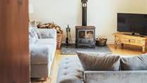 The comfortable sitting-room is very spacious with doors out on to the patio.