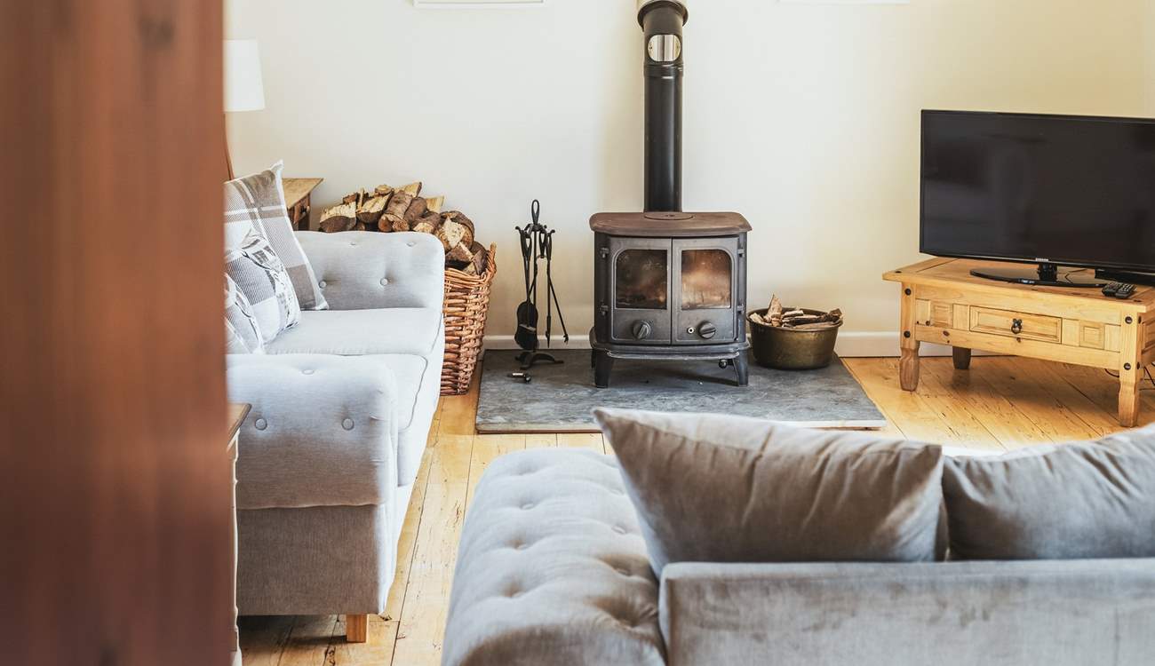 The comfortable sitting-room is very spacious with doors out on to the patio.