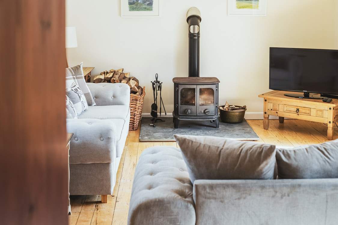 The comfortable sitting-room is very spacious with doors out on to the patio.