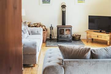 The comfortable sitting-room is very spacious with patio doors out on to the patio.
