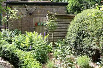 Additional outside seating, barbecue and loungers are stored in the garden shed.