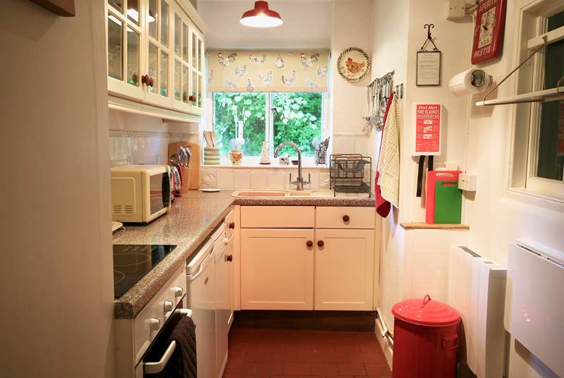 The extremely well equipped kitchen looks out over the side garden and to the field beyond.