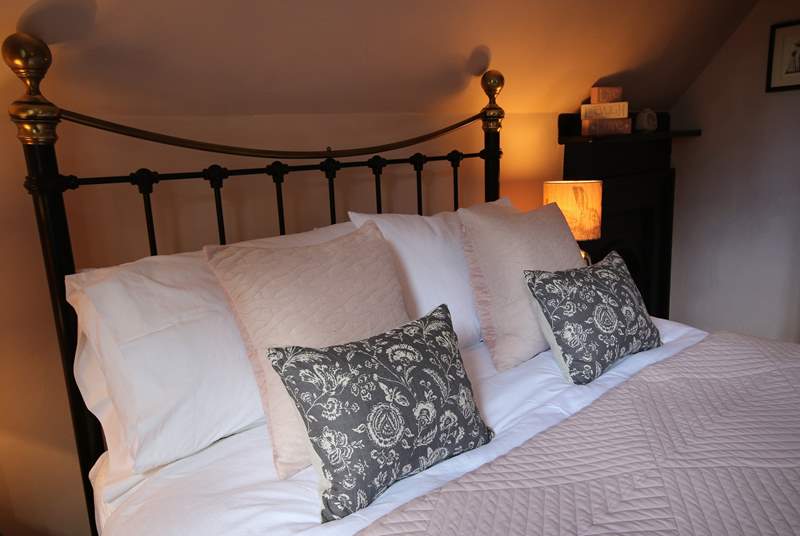 Snuggle up in the evening under quality linen in an antique brass bed.