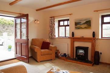 A door from the sitting-room opens onto the patio outside the cottage.