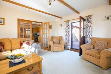 The door in the sitting-room leads out to a sheltered patio.