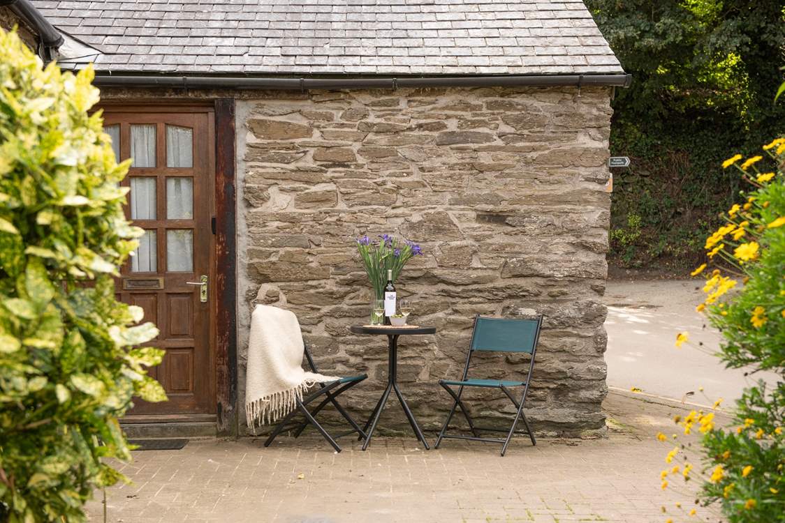 There is a little bistro table situated at the front of the cottage.