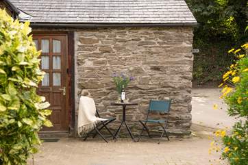There is a little bistro table situated at the front of the cottage.