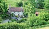 The cottage nestles to the left-hand side of the farmhouse. This is a wonderful Exmoor setting, where dogs are welcome and walks are wonderful. The garden is just to the left of the cottage. - Thumbnail Image