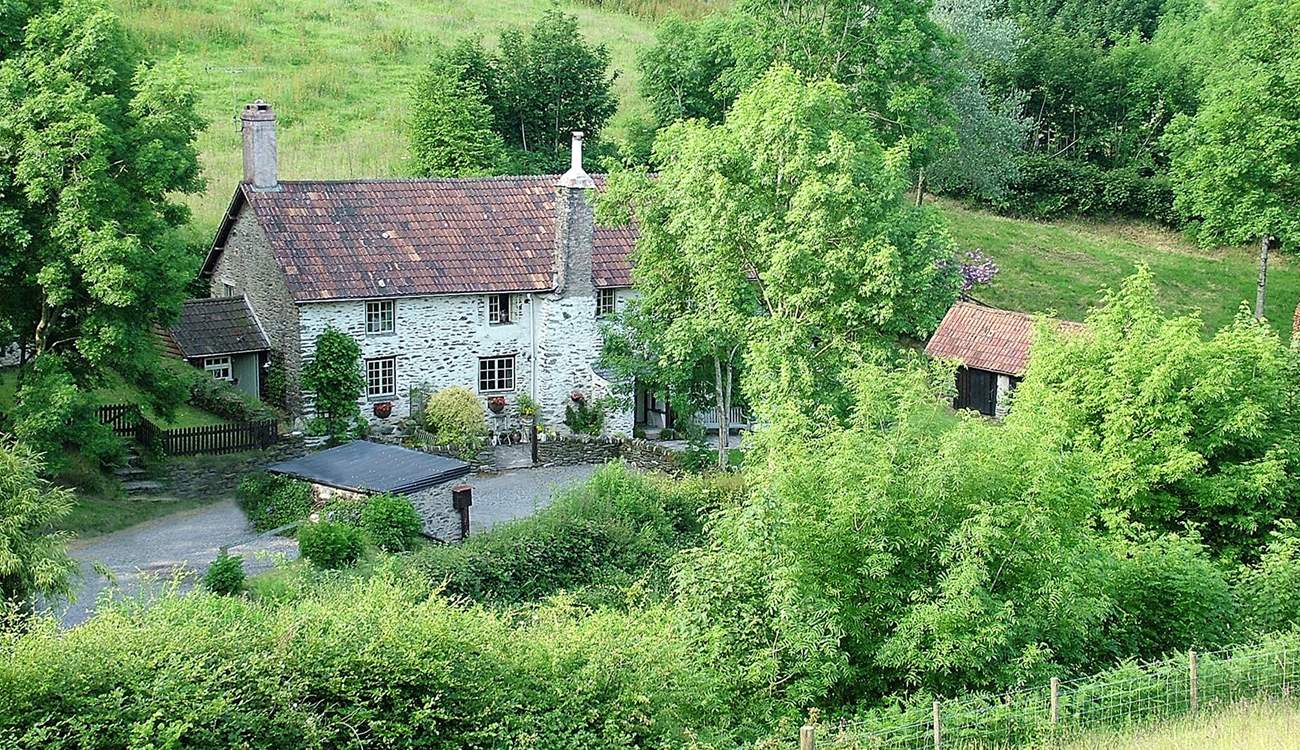 The cottage nestles to the left-hand side of the farmhouse. This is a wonderful Exmoor setting, where dogs are welcome and walks are wonderful. The garden is just to the left of the cottage.