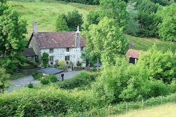 The cottage nestles to the left-hand side of the farmhouse. This is a wonderful Exmoor setting, where dogs are welcome and walks are wonderful. The garden is just to the left of the cottage.