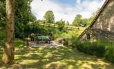 This is the enclosed side garden with picnic table and fitted barbecue. - Thumbnail Image