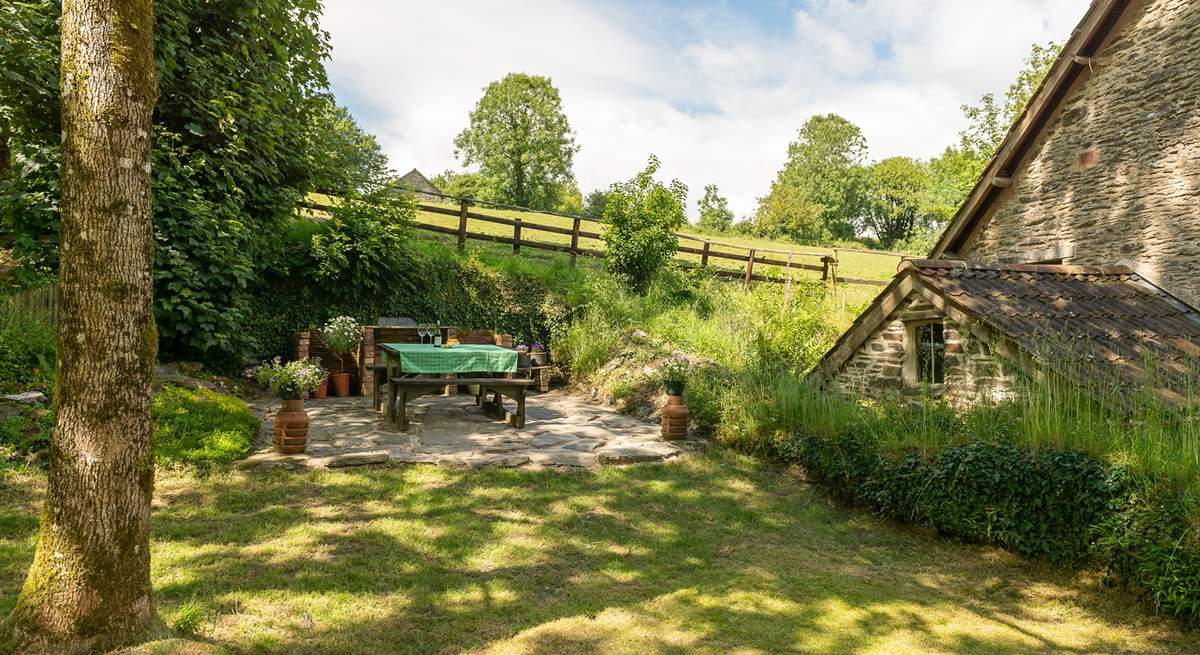 This is the enclosed side garden with picnic table and fitted barbecue.