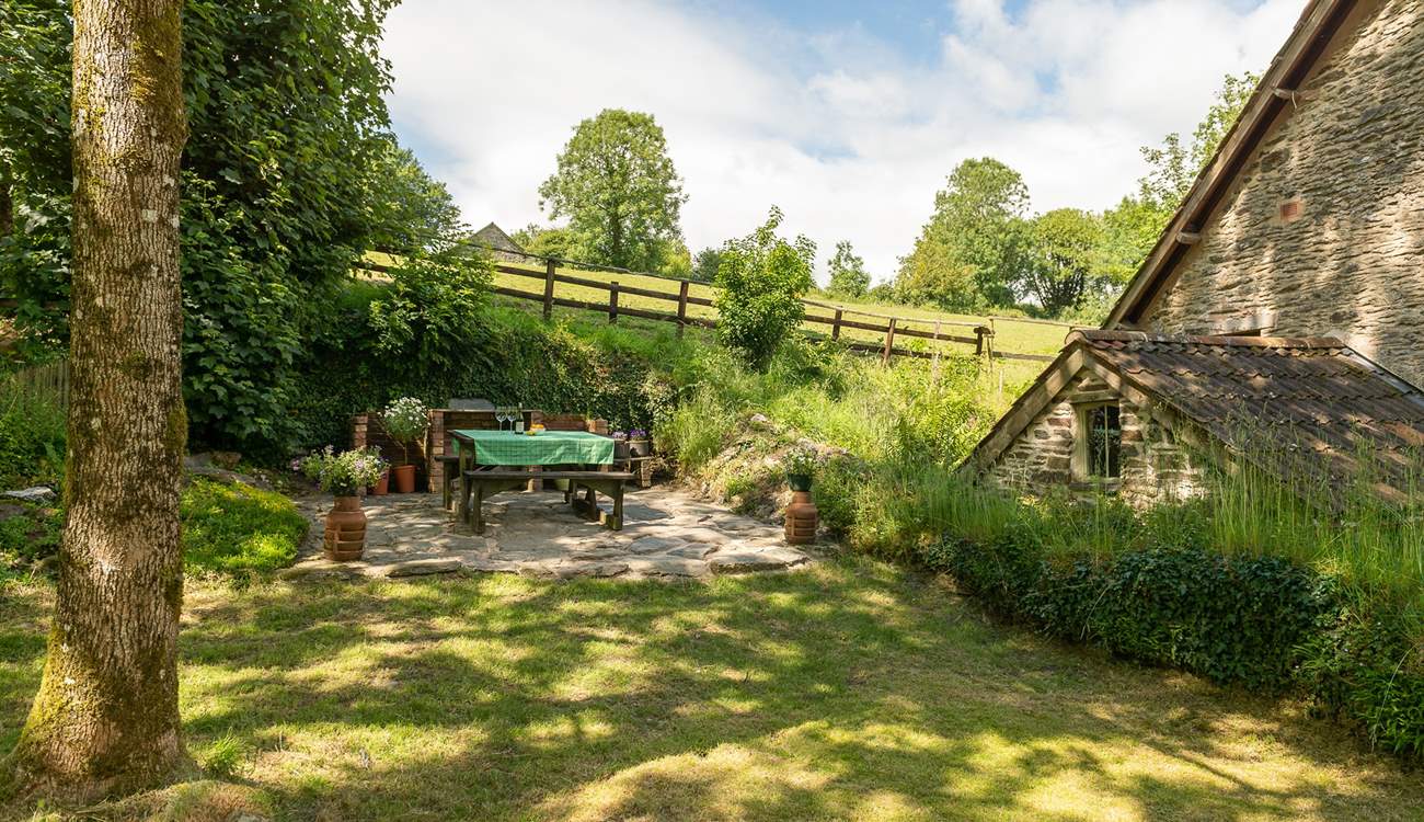 This is the enclosed side garden with picnic table and fitted barbecue.