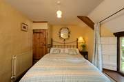 The bedroom with its antique brass bed is on the first floor, at the top of the turning cottage stairs.
