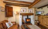 The open plan ground floor has a wood-burning stove and so much character. - Thumbnail Image