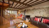 There is a beautiful sitting/dining-room with a wood-burner and French windows to the enclosed garden.