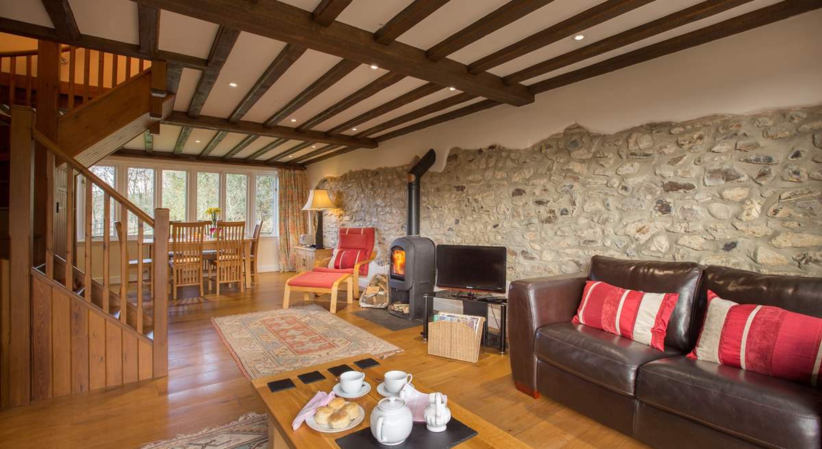 There is a beautiful sitting/dining-room with a wood-burner and French windows to the enclosed garden.