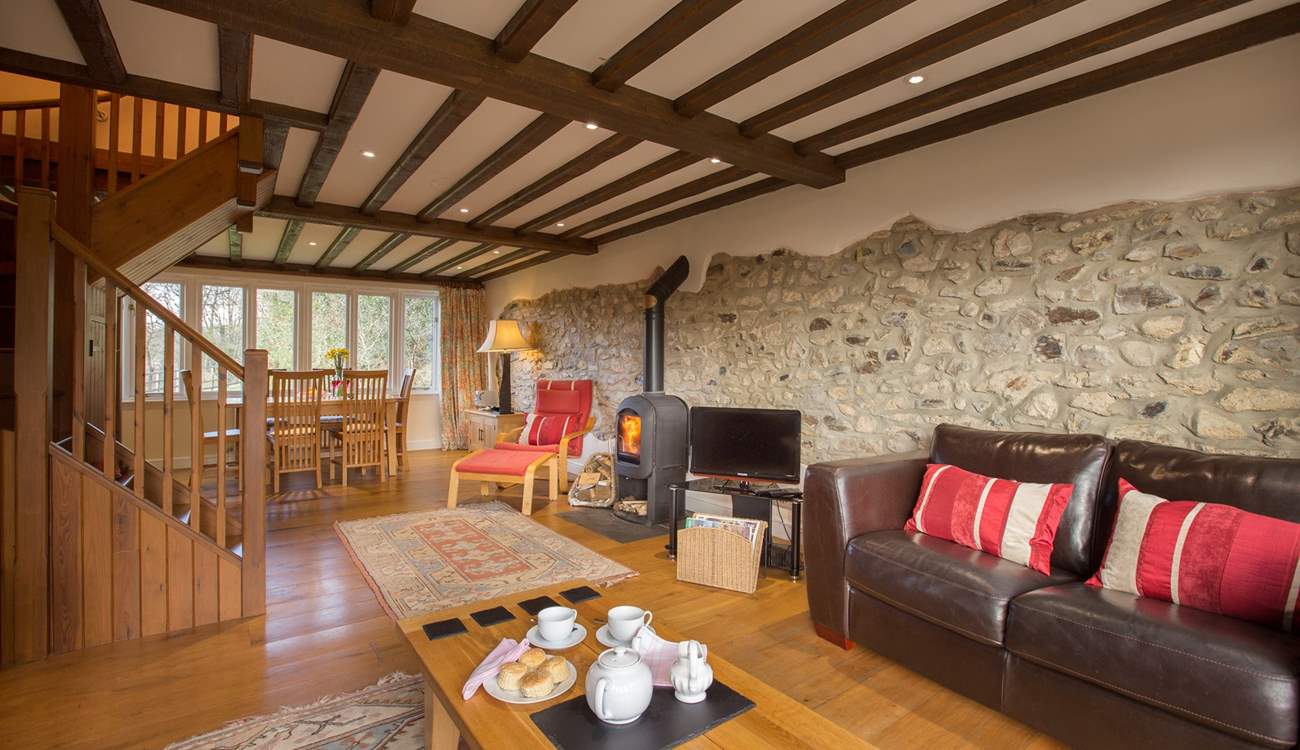 There is a beautiful sitting/dining-room with a wood-burner and French windows to the enclosed garden.