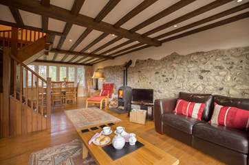 There is a beautiful sitting/dining-room with a wood-burner and French windows to the enclosed garden.
