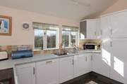 The dual-aspect kitchen makes the most of the amazing views from the cottage - all the way to Dartmoor!