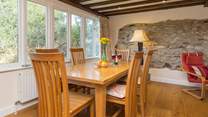 The dining-table is at one end of this large open plan living space.