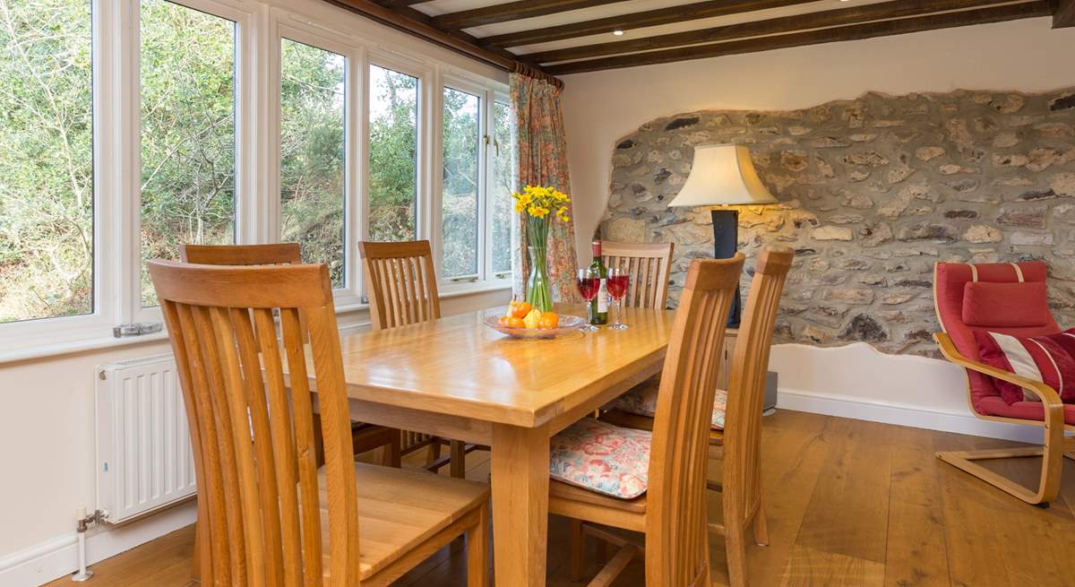 The dining-table is at one end of this large open plan living space.