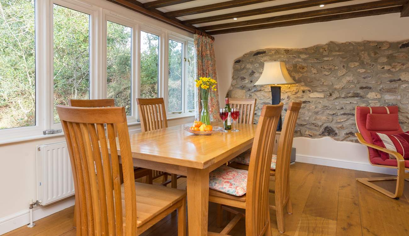 The dining-table is at one end of this large open plan living space.