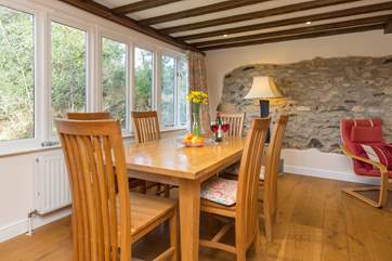 The dining-table is at one end of this large open plan living space.