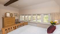 The windows stretch the full width of the room, so you can lie in bed and look at the woodland across the field.