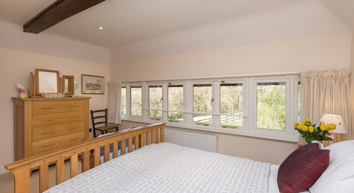 The windows stretch for the full width of the room, so you can lie in bed and look at the woodland across the field.