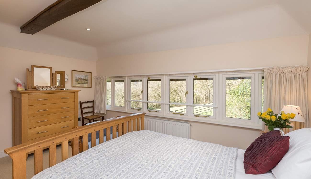 The windows stretch the full width of the room, so you can lie in bed and look at the woodland across the field.