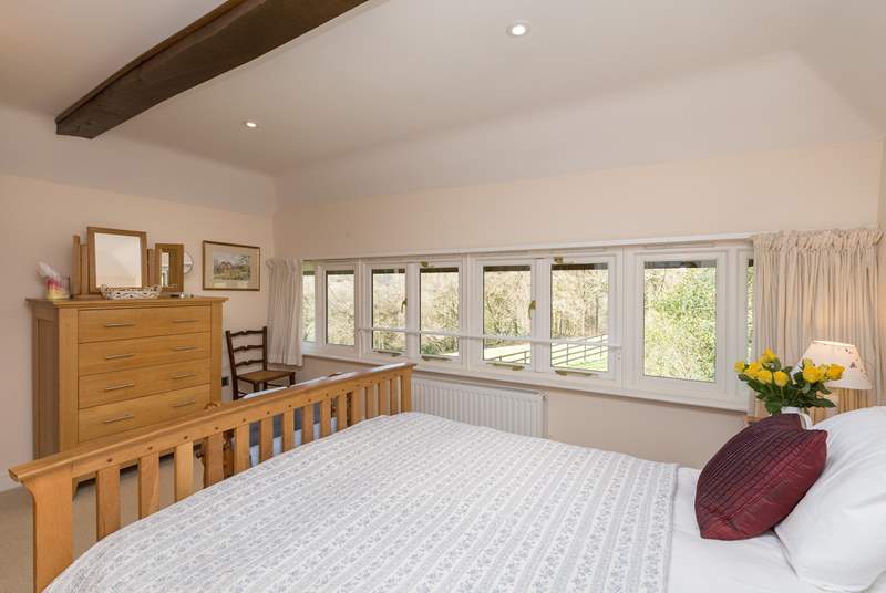 The windows stretch for the full width of the room, so you can lie in bed and look at the woodland across the field.