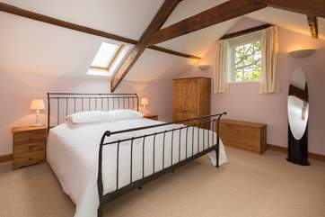 The bedrooms and bathrooms are on the first floor. This is the master bedroom with its super-king size bed.