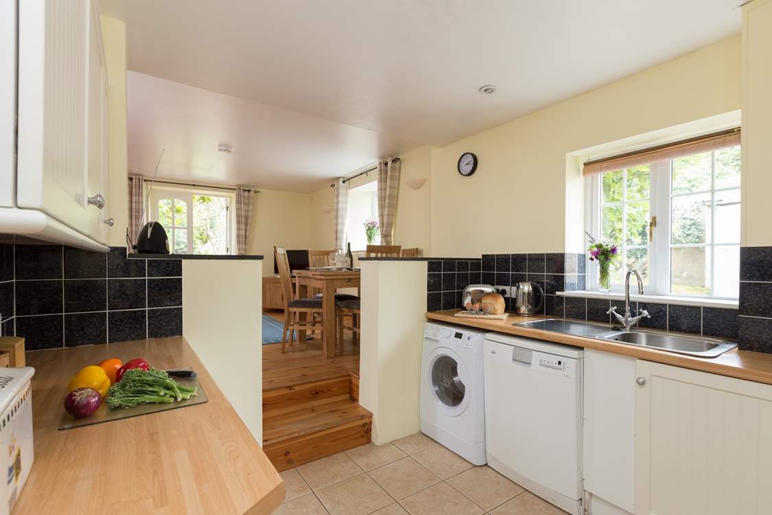 The kitchen is part of the open plan layout and accessed by steps down.  The kitchen is well is equipped to cook up a storm or the holiday fry up!