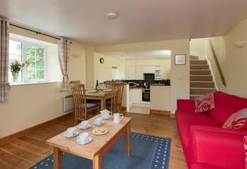 The ground floor is a cheerful open plan layout, with steps down to the kitchen-area.