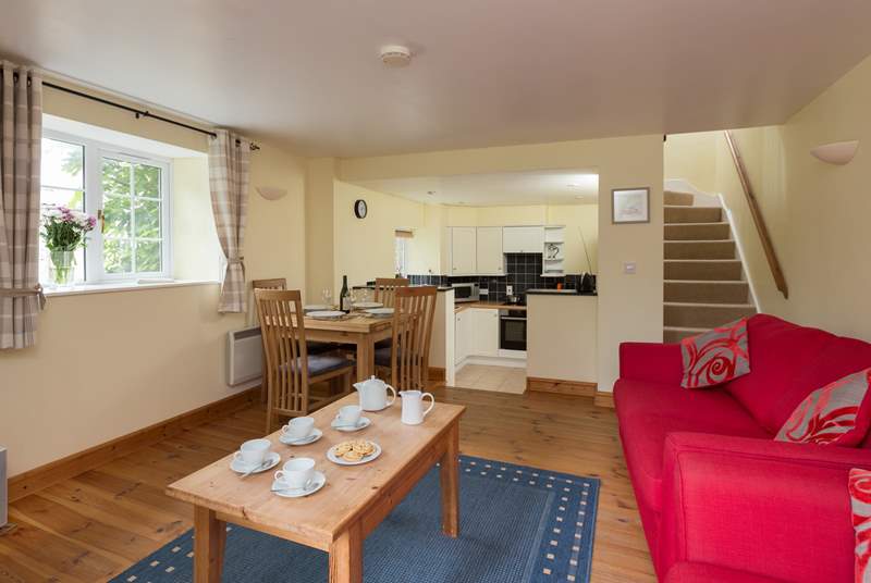 The ground floor is a cheerful open plan layout, with steps down to the kitchen-area.
